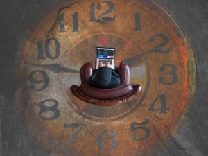 Clock with person on computer in the center