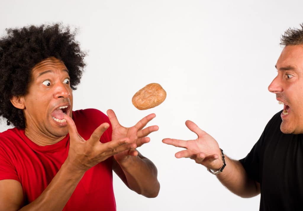 Person tossing a hot potato to another person