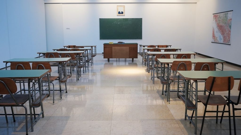 classroom with desks and chalkboard