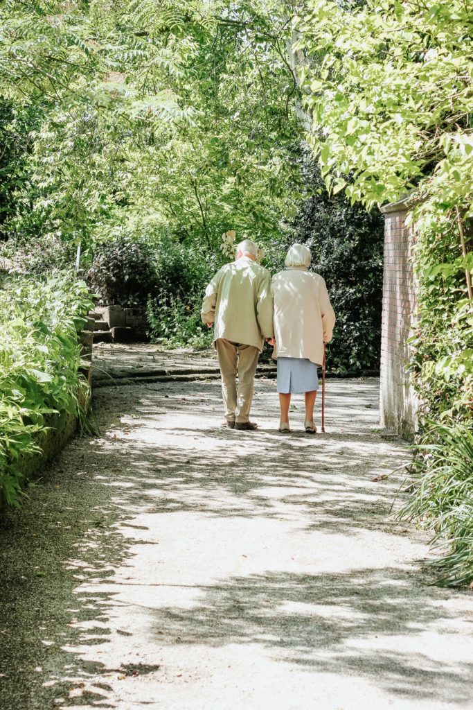 Elderly couple walking along a path