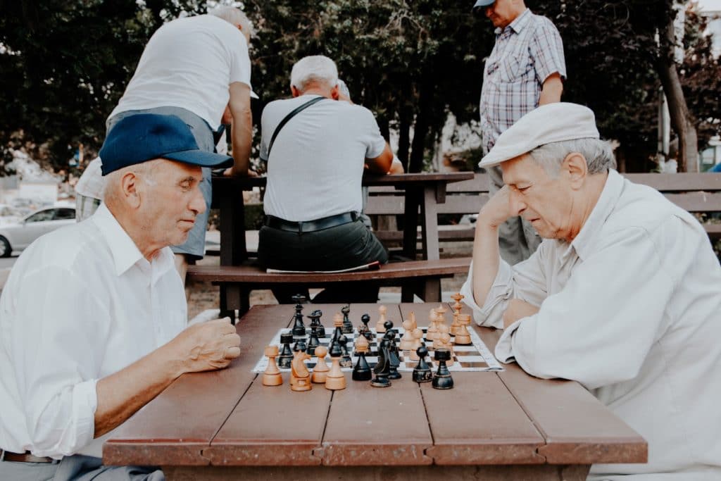 Men playing chess in the park