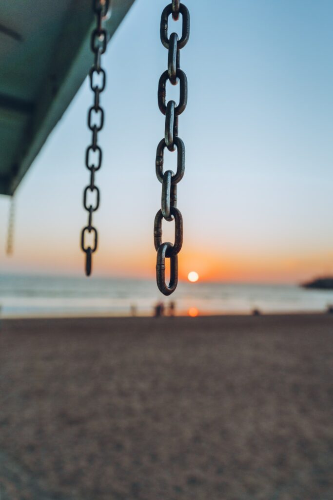 Chains hanging from a beach pier