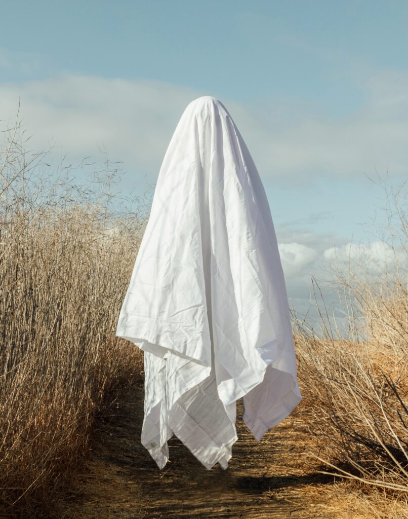 Bed sheet "ghost" levitating over a field.