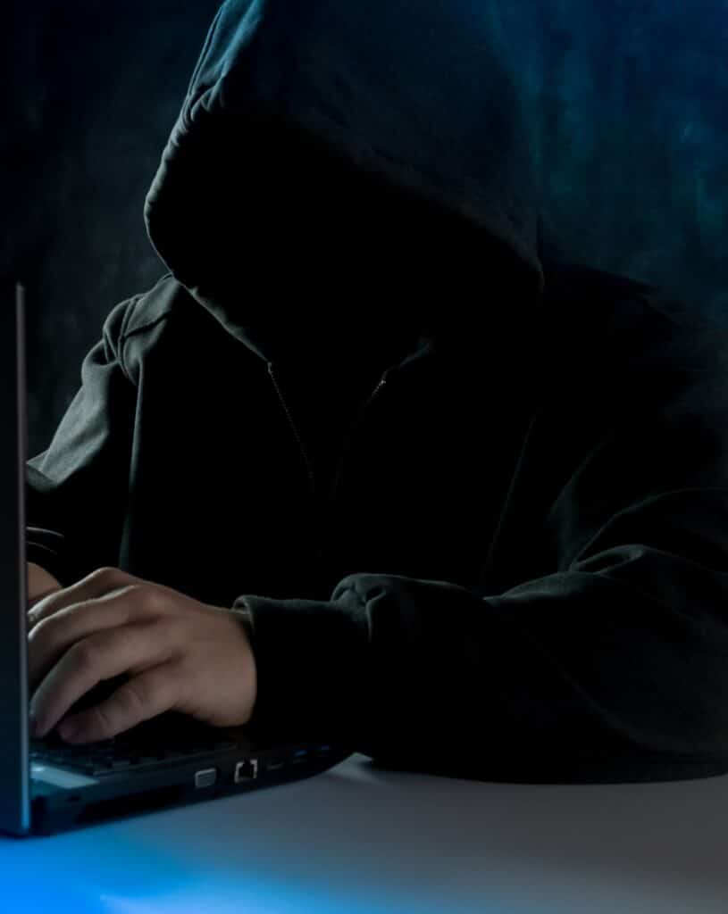 computer hacker working on a laptop