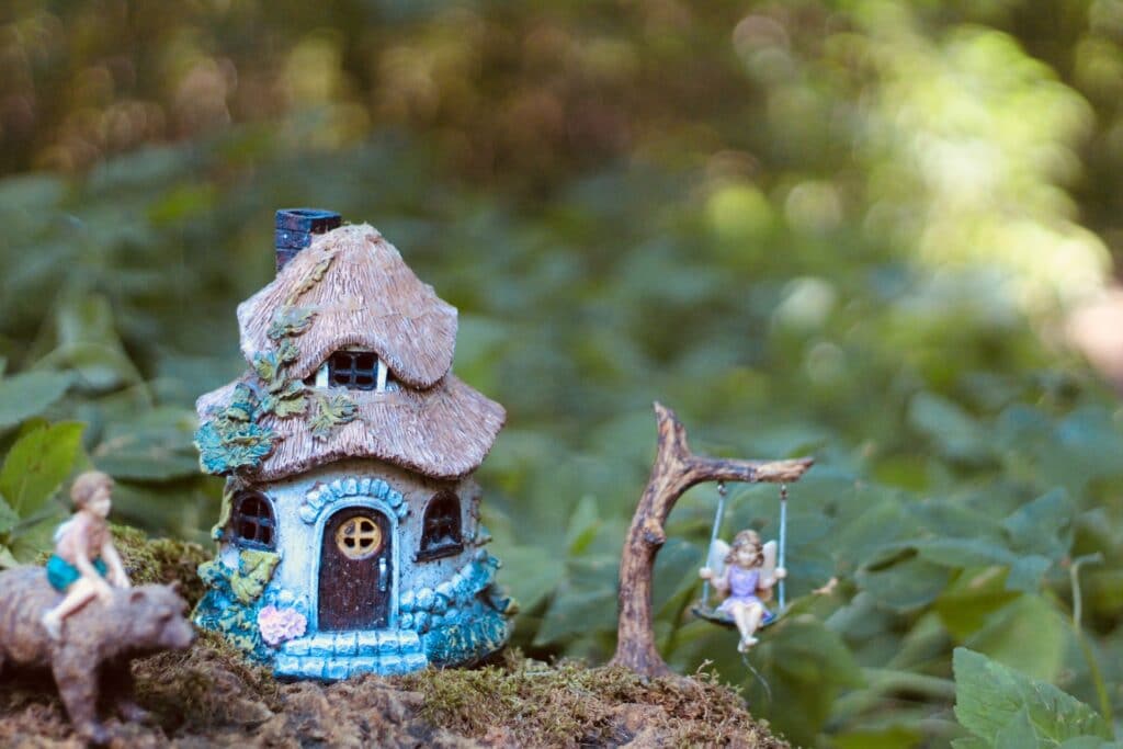 small model of a cottage and children at play