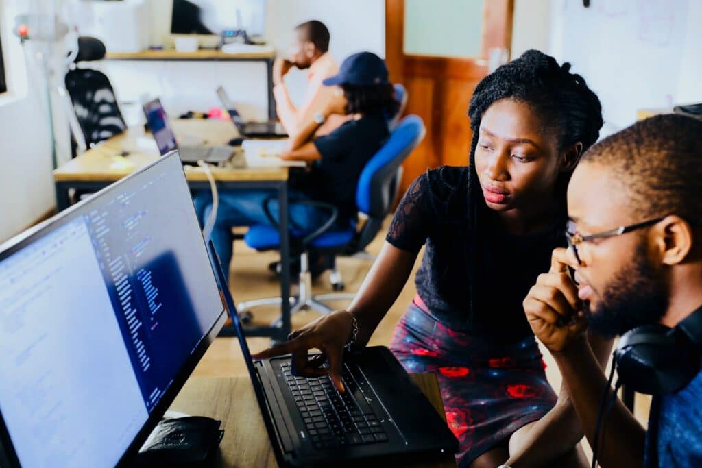 Students looking at text on a computer screen