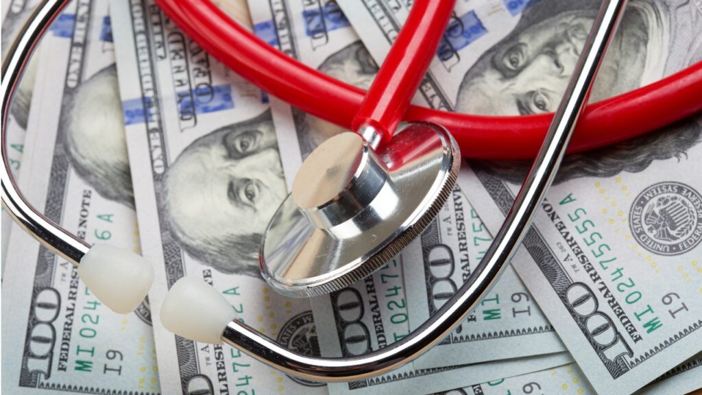 stethoscope on a pile of $100 bills