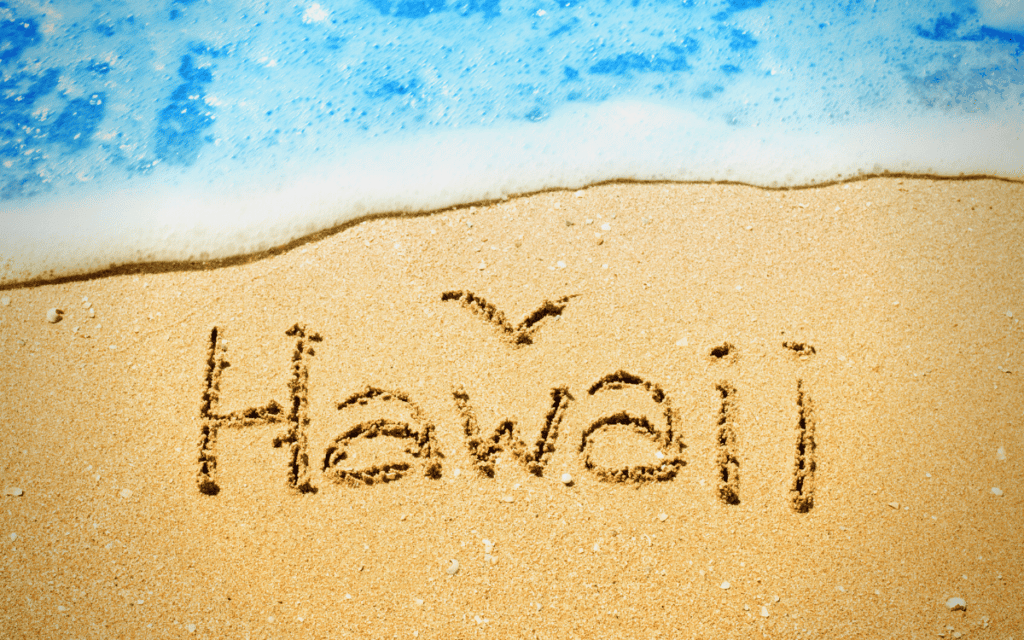 "Hawaii" written in the sand