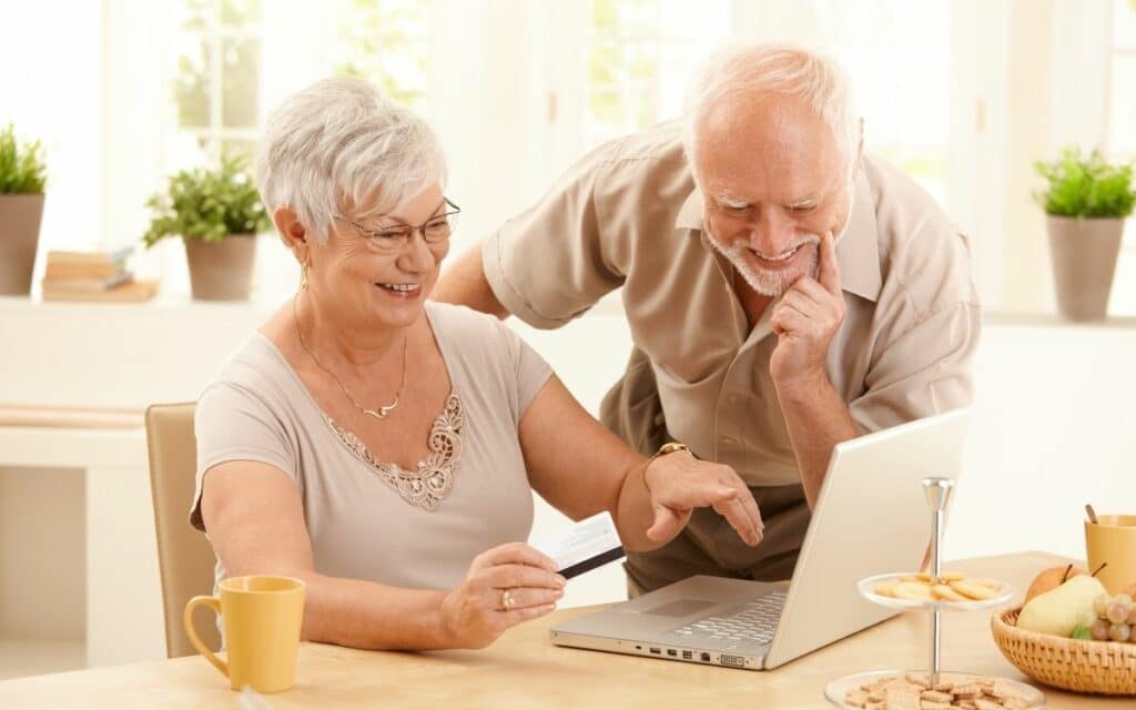 Older couple looking at something on a laptop computer.